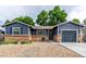 Charming single-story home with a brick foundation, blue siding, and a well-manicured front yard at 8696 W 86Th Cir, Arvada, CO 80005