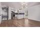 Open-concept kitchen features stainless steel appliances, a breakfast bar, and modern lighting at 8696 W 86Th Cir, Arvada, CO 80005