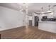 Bright kitchen showcases white cabinets, a stainless steel refrigerator, and hardwood floors at 8696 W 86Th Cir, Arvada, CO 80005