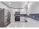 Contemporary kitchen featuring white cabinetry, stainless appliances, and a quartz countertop at 8696 W 86Th Cir, Arvada, CO 80005