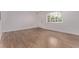 Bright living room showcases beautiful hardwood floors, a window, and a white front door at 8696 W 86Th Cir, Arvada, CO 80005