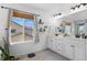Bright bathroom with a double sink vanity, large window, and neutral decor at 6454 Leathers Ln, Parker, CO 80134