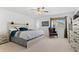 Bedroom with a light-colored wood bed frame, accent pillows, a large window, and a sitting chair at 6454 Leathers Ln, Parker, CO 80134