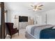 Bedroom featuring a large TV on a dresser, a seating chair, and double doors to another room at 6454 Leathers Ln, Parker, CO 80134