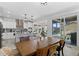 Bright dining room that connects to the kitchen, featuring a dining table and a sliding glass door at 6454 Leathers Ln, Parker, CO 80134