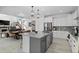 Open kitchen and dining area with an island, stainless steel appliances, and a view into the living room at 6454 Leathers Ln, Parker, CO 80134