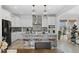 Modern kitchen featuring a large island, stainless steel appliances, and pendant lighting at 6454 Leathers Ln, Parker, CO 80134