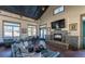 Open concept living room with fireplace, large windows, and vaulted ceiling at 6454 Leathers Ln, Parker, CO 80134