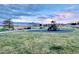 A playground in a common area with a pavilion and benches at sunset at 6454 Leathers Ln, Parker, CO 80134