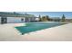 Community pool with a retractable cover, and a nearby building with a green roof at 6454 Leathers Ln, Parker, CO 80134
