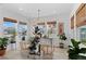 Bright sunroom featuring natural light, plants, light fixtures, and decorative window coverings at 6454 Leathers Ln, Parker, CO 80134