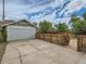 Garage, concrete drive, and backyard area with gated access define the exterior at 1615 Osceola St, Denver, CO 80204