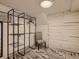 Finished basement area offering ample storage with a metal shelving unit and a chair at 1615 Osceola St, Denver, CO 80204
