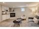 Basement rec room featuring neutral colors, a modern fireplace, kitchenette, and comfortable seating area at 1615 Osceola St, Denver, CO 80204