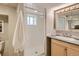 Bright bathroom with a glass-enclosed shower, vanity with ample storage, and neutral decor at 1615 Osceola St, Denver, CO 80204