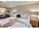 Bedroom featuring plush bedding, ambient lighting, and a comfortable seating area for relaxation at 1615 Osceola St, Denver, CO 80204