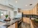 Compact kitchen features an island and stainless steel appliances at 1615 Osceola St, Denver, CO 80204