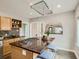 Kitchen island with gas cooktop and hanging pot rack, offering a functional workspace and eating area at 1615 Osceola St, Denver, CO 80204