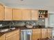 This kitchen features wooden cabinets and stainless steel appliances at 1615 Osceola St, Denver, CO 80204