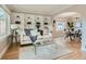 Inviting living room boasts custom built-in shelving, hardwood floors, and a sun-drenched window at 1615 Osceola St, Denver, CO 80204