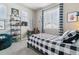 Stylish bedroom with a black and white palette, featuring a cozy bed and decorative shelving at 26088 E Calhoun Pl, Aurora, CO 80016