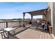 Spacious deck area with a covered pergola, patio furniture, and scenic views of the surrounding neighborhood at 26088 E Calhoun Pl, Aurora, CO 80016