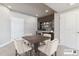 A dining area with dark wooden table and seating for four, as well as a built-in bar at 26088 E Calhoun Pl, Aurora, CO 80016