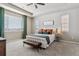 Serene main bedroom features a plush bed, tray ceilings, carpet flooring, and bright windows at 26088 E Calhoun Pl, Aurora, CO 80016