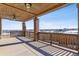 Covered patio featuring brick pillars, a wood ceiling with fans, and scenic views of the neighborhood at 26088 E Calhoun Pl, Aurora, CO 80016