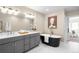A bathroom featuring a tub and double vanity at 1688 S Grant St, Denver, CO 80210