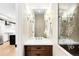 Well-lit powder room with stylish vanity and modern fixtures, conveniently located near the kitchen at 1688 S Grant St, Denver, CO 80210