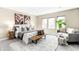 Bright bedroom featuring soft gray tones, area rug, and sitting area bathed in natural light at 1688 S Grant St, Denver, CO 80210