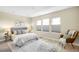 Bright bedroom features soft gray tones, area rug, and chair bathed in natural light at 1688 S Grant St, Denver, CO 80210