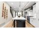 Bright kitchen features an island with bar seating, stainless steel appliances, and pendant lighting at 1688 S Grant St, Denver, CO 80210