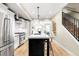 Modern kitchen featuring stainless steel appliances, a center island, and ample counter space at 1688 S Grant St, Denver, CO 80210