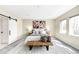 Serene primary bedroom features a sliding barn door, cozy rug, and natural light at 1688 S Grant St, Denver, CO 80210
