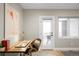 Bright office space with a desk, modern chair, and a door leading to an outdoor patio at 1688 S Grant St, Denver, CO 80210