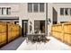 Outdoor patio with dining table, chairs, decorative lights and fenced yard at 1688 S Grant St, Denver, CO 80210