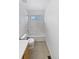 Bathroom features a shower-tub combination with tile surround and neutral tile flooring at 3932 S Quatar St, Aurora, CO 80018