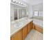 Bright bathroom with double sink vanity, tiled floors, soaking tub, and walk-in shower at 3932 S Quatar St, Aurora, CO 80018