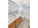 Bathroom with wood cabinet, neutral countertop, and tile flooring at 3932 S Quatar St, Aurora, CO 80018