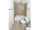 Bathroom with tiled shower, toilet, and towel rack at 3932 S Quatar St, Aurora, CO 80018