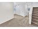 Bedroom featuring neutral carpet, a closet, and a staircase at 3932 S Quatar St, Aurora, CO 80018
