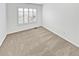 Well-lit bedroom features neutral carpet and a window with white shutters at 3932 S Quatar St, Aurora, CO 80018