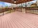 Large wooden deck with railing and covered area perfect for outdoor relaxation at 3932 S Quatar St, Aurora, CO 80018