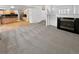 Carpeted living room featuring a fireplace and connecting to the kitchen and staircase at 3932 S Quatar St, Aurora, CO 80018