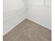 Bright walk-in closet with wire shelving and neutral carpet flooring at 3932 S Quatar St, Aurora, CO 80018