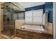 Luxurious bathroom with a soaking tub, walk-in shower, and tile accents, offering a spa-like experience at 1113 Southbury Pl, Highlands Ranch, CO 80129