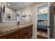 Elegant bathroom featuring granite countertops, wood cabinetry, and modern fixtures at 1113 Southbury Pl, Highlands Ranch, CO 80129