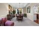 Elegant dining room featuring a tray ceiling, large windows, and sophisticated decor at 1113 Southbury Pl, Highlands Ranch, CO 80129